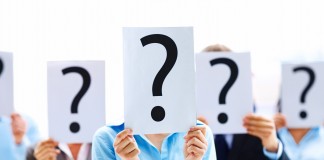 Business people standing with question mark on boards