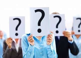 Business people standing with question mark on boards
