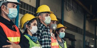 Factory workers with face mask protect from outbreak of Corona Virus Disease 2019 or COVID-19.