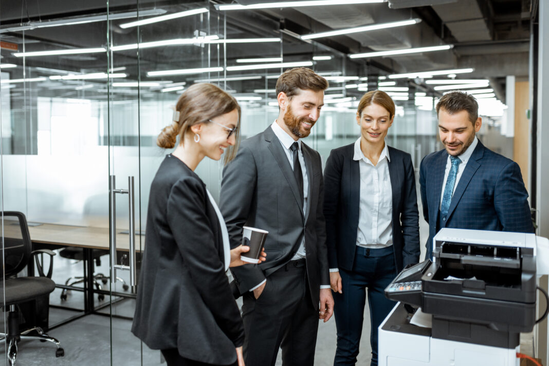 Business people near the copier in the hallway